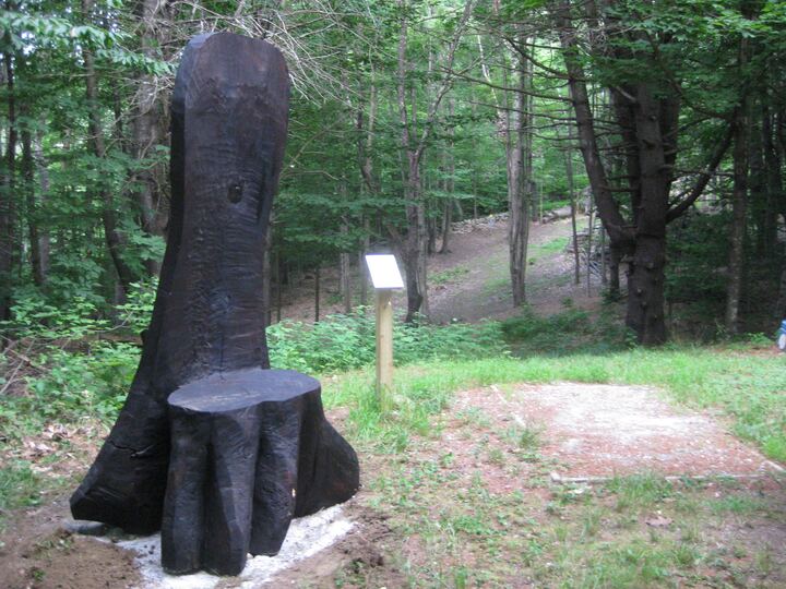 Carved wooden chair beside hole 4